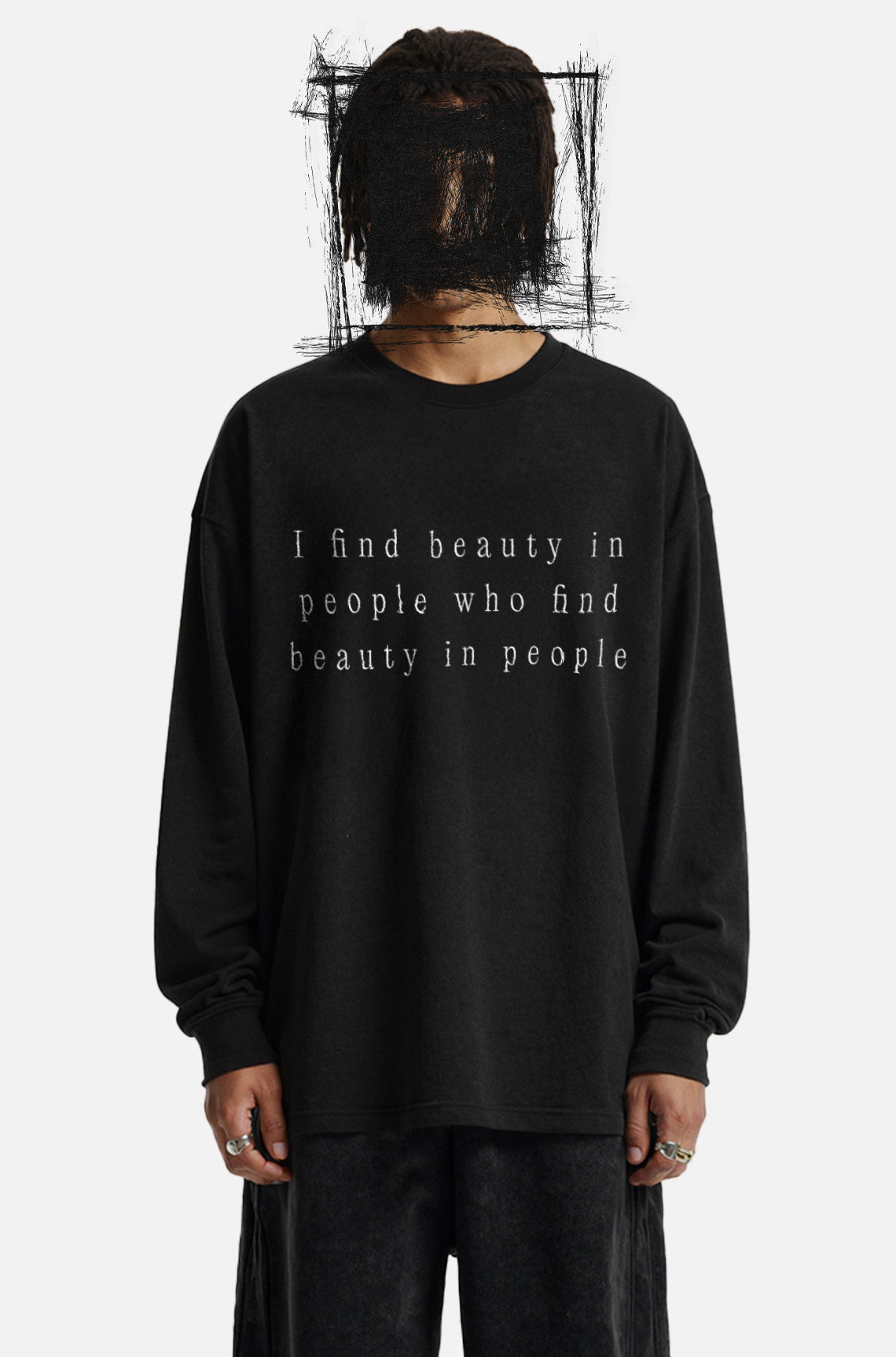 Person wearing a black long-sleeve shirt with text on a white background