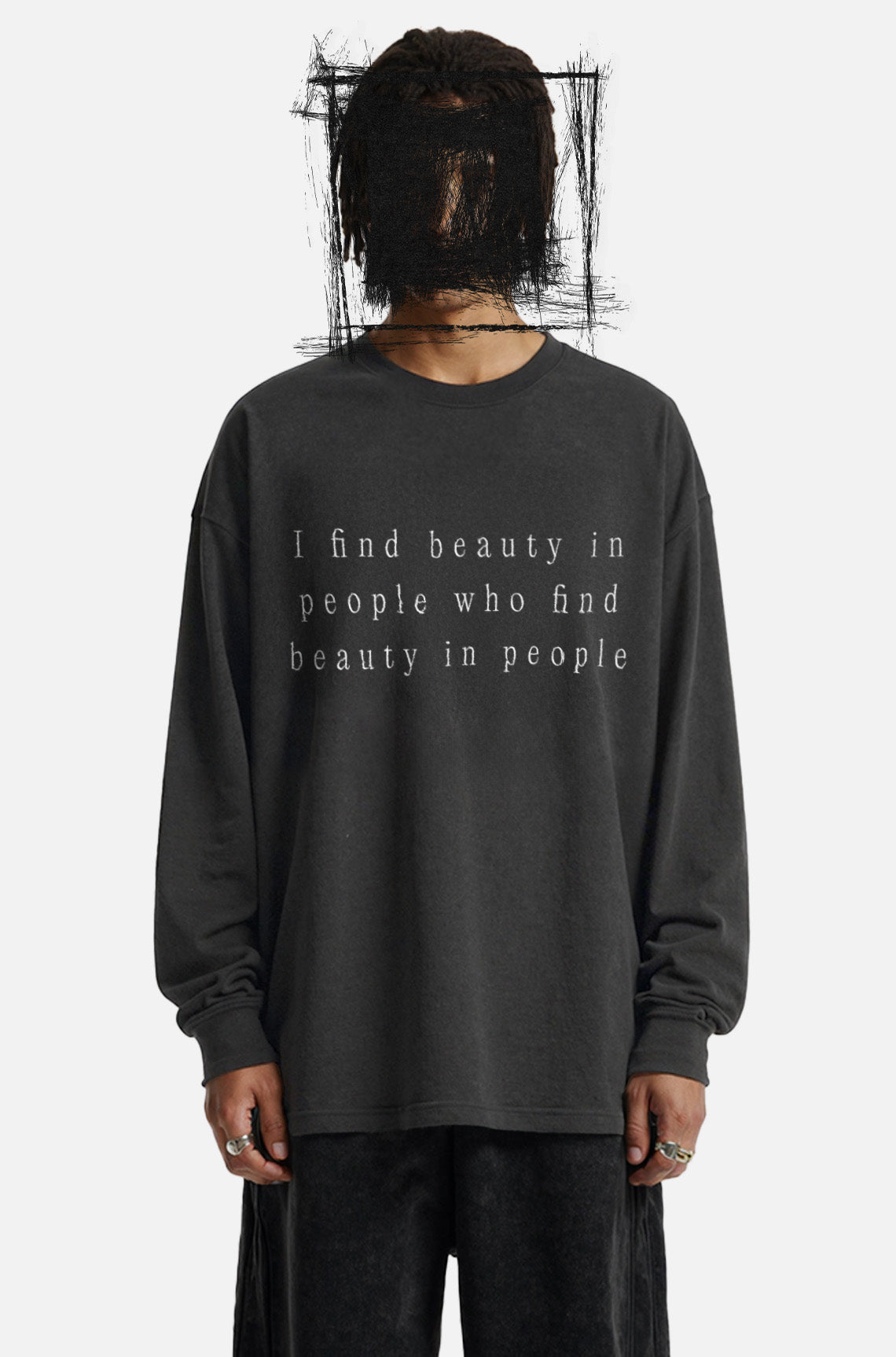 Person wearing a black long-sleeve shirt with text on a white background